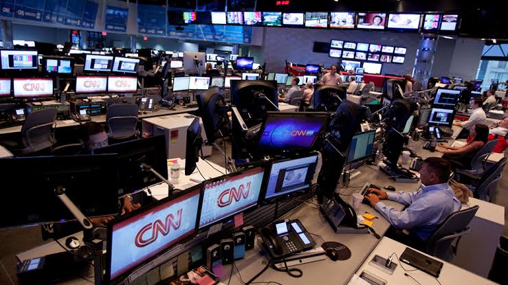 International newsroom where editors process and interpret diplomatic statements for foreign news coverage.